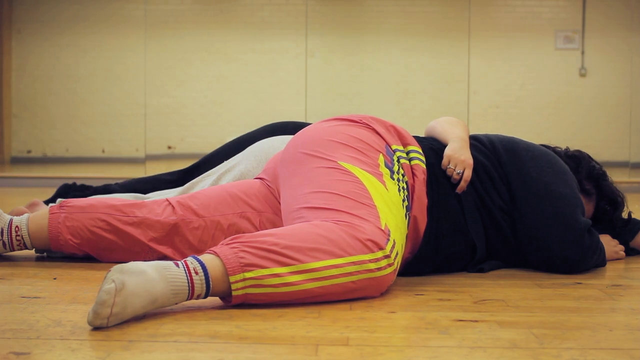 Gillie Kleiman and two other fat dancers on a dance studio floor, bodies tucked against each other.